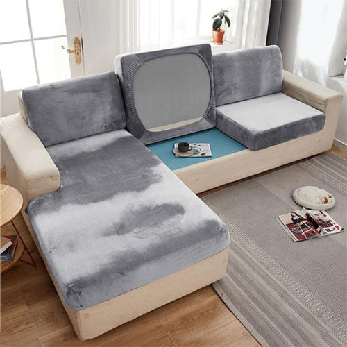 housse canapé d'angle dans les coloris de gris sur un canapé dans un salon bien décoré
