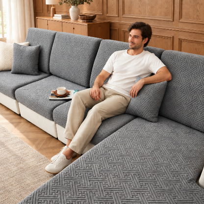 housse de canape d angle gris foncé à motifs romains avec une homme assis dans un salon décoré avec des  boiseries