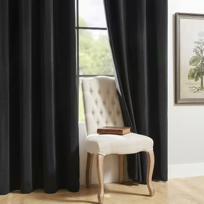 rideaux pour salon noir avec une chaise capitonée blanche au centre